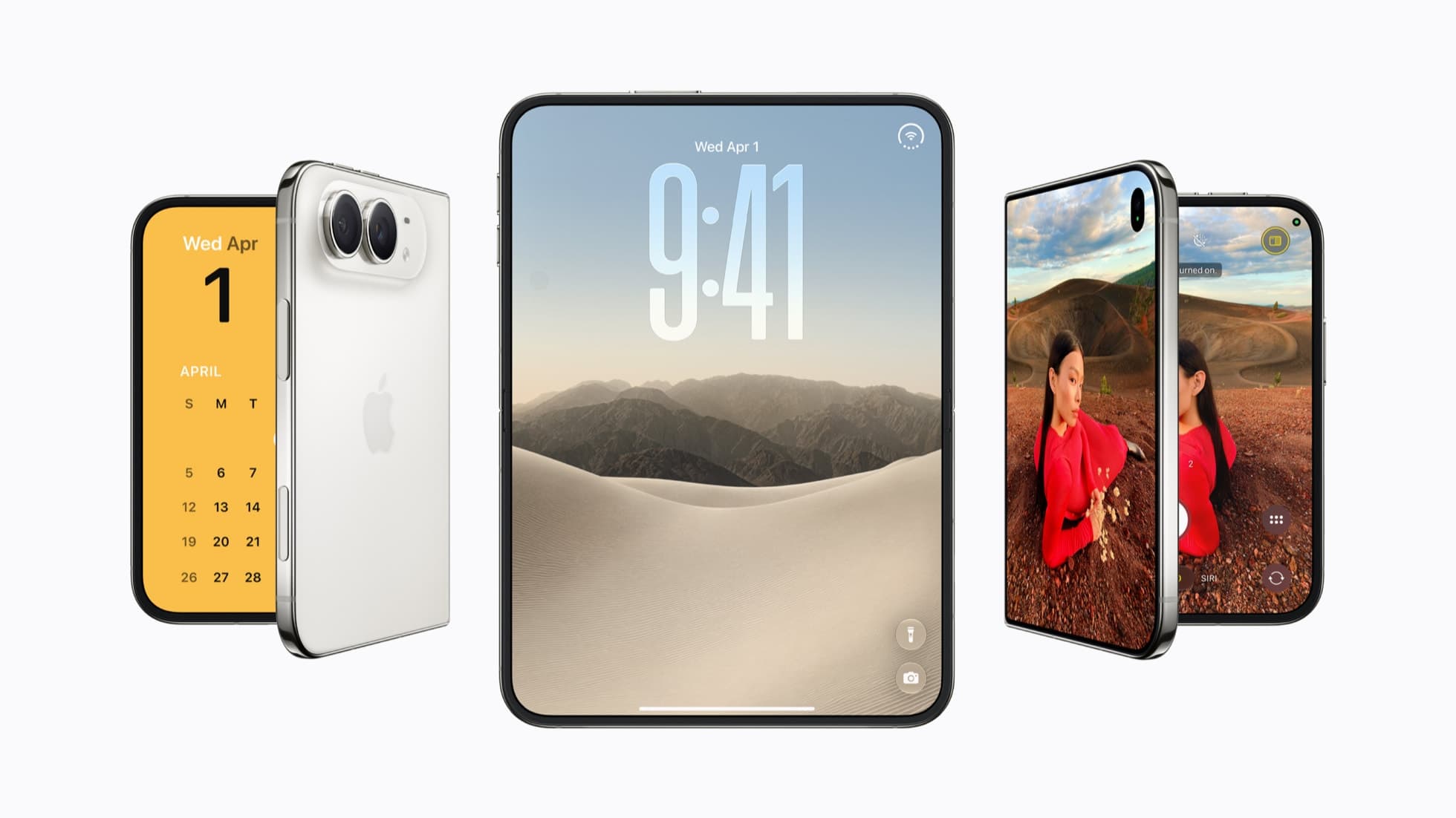 Three iPhone Duo phones on a white background: a star white one on the left, partly folded, with a yellow April calendar on its outer screen and two rear cameras showing; one in the center open flat to its inner display, which shows a Lock Screen reading Wed Apr 1 and 9:41 over sand dunes and mountains; and one on the right, partly folded, with the Camera app on both panels showing a woman in a red sweater lying on red earth.