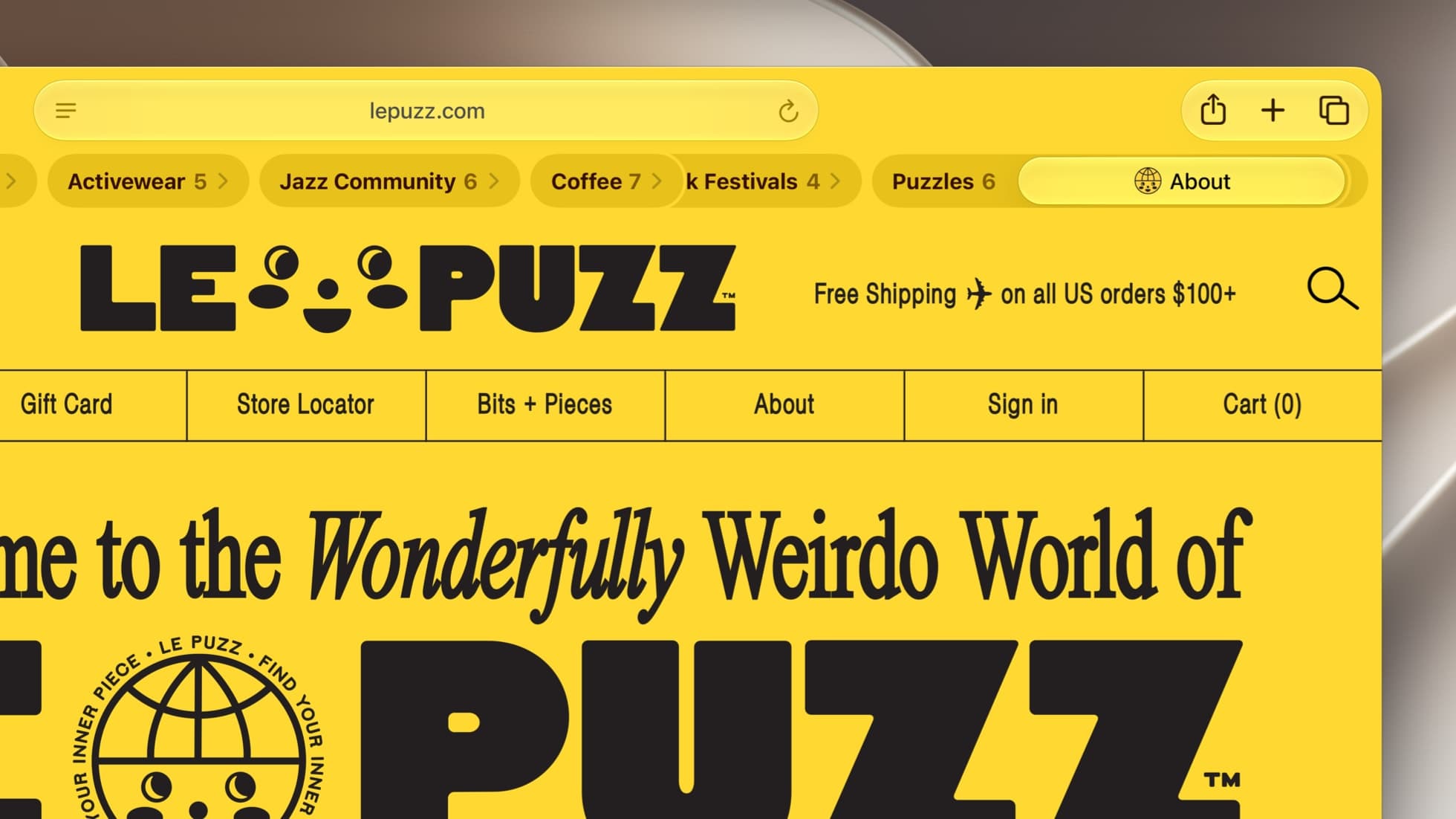 A close crop of a Safari window showing the yellow lepuzz.com home page, with the tab bar grouped into topics labeled Activewear 5, Jazz Community 6, Coffee 7, a partly hidden Festivals 4 and Puzzles 6 beside an About tab, and the Le Puzz logo and a navigation row reading Gift Card, Store Locator, Bits + Pieces, About, Sign in and Cart below.